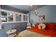 Cozy bedroom with large windows, comfortable bedding, and playful decor for a  at 5809 W Morten Ave, Glendale, AZ 85301