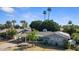 Beautiful home with mature landscaping, solar panels, a carport, and a basketball hoop at 5809 W Morten Ave, Glendale, AZ 85301