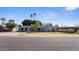 Charming single-story home with a covered carport, well-maintained lawn, and mature landscaping at 5809 W Morten Ave, Glendale, AZ 85301
