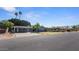 Charming home with a covered carport, solar panels, and a basketball hoop at 5809 W Morten Ave, Glendale, AZ 85301