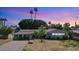 Charming single-story home featuring a large front yard with a basketball hoop and mature trees at 5809 W Morten Ave, Glendale, AZ 85301