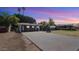 Charming single-story home featuring a long driveway with a basketball hoop and mature trees at 5809 W Morten Ave, Glendale, AZ 85301