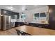 Spacious kitchen with stainless steel appliances, dark cabinets, and an eat-in area at 5809 W Morten Ave, Glendale, AZ 85301