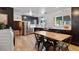 Well-lit kitchen features black cabinetry, stainless steel appliances, and a dining area at 5809 W Morten Ave, Glendale, AZ 85301