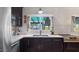 Modern kitchen with stainless steel appliances, white countertops, and dark cabinetry at 5809 W Morten Ave, Glendale, AZ 85301