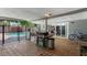 Inviting covered patio area with outdoor seating, a grill, and a view of the pool at 5809 W Morten Ave, Glendale, AZ 85301
