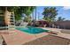 Outdoor pool area with diving board, lounge chairs, and lush landscaping, perfect for relaxation at 5809 W Morten Ave, Glendale, AZ 85301