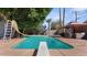 Relaxing backyard featuring a private pool with a diving board and a covered patio at 5809 W Morten Ave, Glendale, AZ 85301