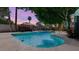 Refreshing backyard pool surrounded by mature trees, a gazebo, and ample space for entertaining at 5809 W Morten Ave, Glendale, AZ 85301