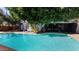 Backyard pool featuring a slide and mature trees offering shade at 5809 W Morten Ave, Glendale, AZ 85301