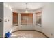 Bright breakfast nook featuring tile floors, three windows with wood blinds, and a modern hanging light fixture at 607 W Palo Verde St, Gilbert, AZ 85233