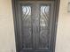 Unique patterned glass double front doors with custom ironwork that add elegance to the entrance at 607 W Palo Verde St, Gilbert, AZ 85233