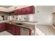 Well-equipped kitchen features granite countertops, stainless steel appliances, and red cabinetry at 607 W Palo Verde St, Gilbert, AZ 85233