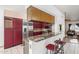 Open kitchen with granite countertops, stainless steel appliances, and red cabinetry at 607 W Palo Verde St, Gilbert, AZ 85233
