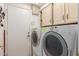 A convenient laundry room featuring a washer, dryer, and ample storage cabinets at 607 W Palo Verde St, Gilbert, AZ 85233