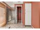 Bright main bathroom featuring a glass-enclosed shower, storage cabinet and tiled floors at 607 W Palo Verde St, Gilbert, AZ 85233