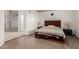 Spacious main bedroom with laminate floors and an open doorway leading to an adjoining living area at 607 W Palo Verde St, Gilbert, AZ 85233
