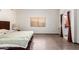 The main bedroom showcases laminate flooring, a window with blinds, and an ensuite bathroom entrance at 607 W Palo Verde St, Gilbert, AZ 85233
