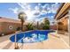 Sparkling pool area with mature palm trees and a rock waterfall feature under a sunny sky at 607 W Palo Verde St, Gilbert, AZ 85233