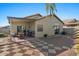 Backyard view showcases a covered patio, stone pavers, and low-maintenance landscaping at 7079 S Kachina Dr, Tempe, AZ 85283