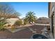 Desert landscaped backyard offering a relaxed setting with seating and a privacy fence at 7079 S Kachina Dr, Tempe, AZ 85283