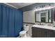 Tiled bathroom with a full shower/tub and sink with mirror, enhanced by modern lighting fixtures at 7079 S Kachina Dr, Tempe, AZ 85283
