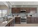 Well-lit kitchen featuring granite countertops and stainless steel appliances at 7079 S Kachina Dr, Tempe, AZ 85283