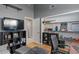 Cozy living room area with a large TV, comfortable seating, and built-in shelving and storage at 7079 S Kachina Dr, Tempe, AZ 85283