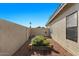 Landscaped side yard with decorative gravel, plant beds, and privacy wall for a serene outdoor space at 7079 S Kachina Dr, Tempe, AZ 85283
