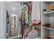 Well-organized walk-in closet with shelves and rods for ample storage and a full length mirror at 7079 S Kachina Dr, Tempe, AZ 85283