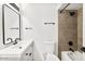 Modern bathroom features a sleek vanity, toilet, and tiled shower-tub combo with black fixtures at 8055 E Thomas Rd # A102, Scottsdale, AZ 85251