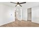 Spacious bedroom with light wood flooring, closet with sliding doors and modern ceiling fan at 8055 E Thomas Rd # A102, Scottsdale, AZ 85251