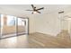 Light-filled bedroom with a ceiling fan, sleek flooring, and a sliding glass door at 8055 E Thomas Rd # A102, Scottsdale, AZ 85251