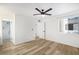 Bright bedroom with ceiling fan, wood-look floors, and access to a modern bathroom at 8055 E Thomas Rd # A102, Scottsdale, AZ 85251