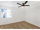 Minimalist bedroom featuring light wood flooring, a modern ceiling fan, and a bright window at 8055 E Thomas Rd # A102, Scottsdale, AZ 85251