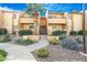 Inviting two-story condo with lush landscaping and a mature palm tree in a well-maintained community at 8055 E Thomas Rd # A102, Scottsdale, AZ 85251