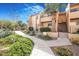 Charming condo building featuring desert landscaping, inviting walkways, and a well-maintained exterior at 8055 E Thomas Rd # A102, Scottsdale, AZ 85251