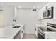 Modern kitchen featuring sleek stainless steel appliances, white cabinets, and quartz countertops at 8055 E Thomas Rd # A102, Scottsdale, AZ 85251