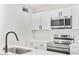 Modern kitchen featuring sleek stainless steel appliances, white cabinets, and quartz countertops at 8055 E Thomas Rd # A102, Scottsdale, AZ 85251