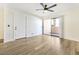 Spacious living room with a ceiling fan, patio access, and sleek, modern flooring at 8055 E Thomas Rd # A102, Scottsdale, AZ 85251