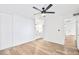 Bright bedroom featuring a ceiling fan, wood floors, and a large closet with sliding doors at 8055 E Thomas Rd # A102, Scottsdale, AZ 85251