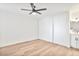 Bright bedroom featuring a ceiling fan, wood floors, and a large closet with sliding doors at 8055 E Thomas Rd # A102, Scottsdale, AZ 85251