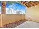 Private outdoor patio area with a view of neighboring white buildings against a blue sky with scattered clouds at 8055 E Thomas Rd # A102, Scottsdale, AZ 85251