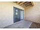 A view of the outdoor patio space featuring the stucco exterior of the building with a sliding glass door entrance at 8055 E Thomas Rd # A102, Scottsdale, AZ 85251