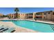 Large community pool with lounge seating on a sunny day at 8055 E Thomas Rd # A102, Scottsdale, AZ 85251