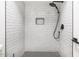 Modern tiled shower featuring a rainfall shower head, built-in niche, and stylish fixtures at 8055 E Thomas Rd # A102, Scottsdale, AZ 85251