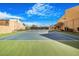 Outdoor tennis court on a sunny day surrounded by landscaping at Woodland Springs Condominiums at 8055 E Thomas Rd # A102, Scottsdale, AZ 85251