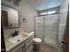 Bathroom featuring vanity with sink, toilet, and walk-in shower with glass doors at 8269 E Desert Trl, Mesa, AZ 85208