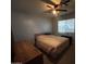Bedroom with a bed, dresser, ceiling fan and a window at 8269 E Desert Trl, Mesa, AZ 85208