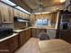 Kitchen with light wood cabinets, countertops, stainless steel appliances, and adjacent dining area with table and chairs at 8269 E Desert Trl, Mesa, AZ 85208